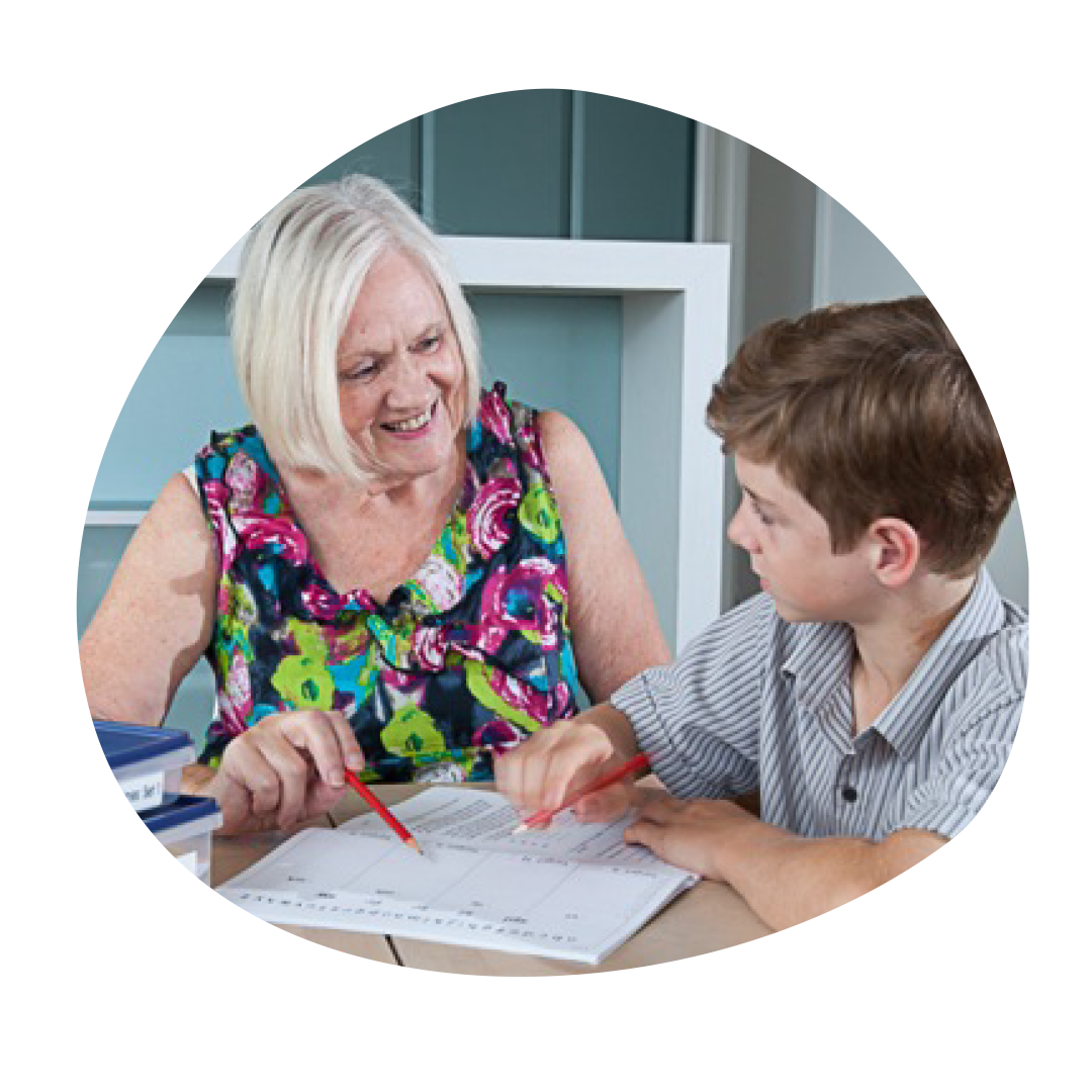 Happy teacher helping student with phonic support
